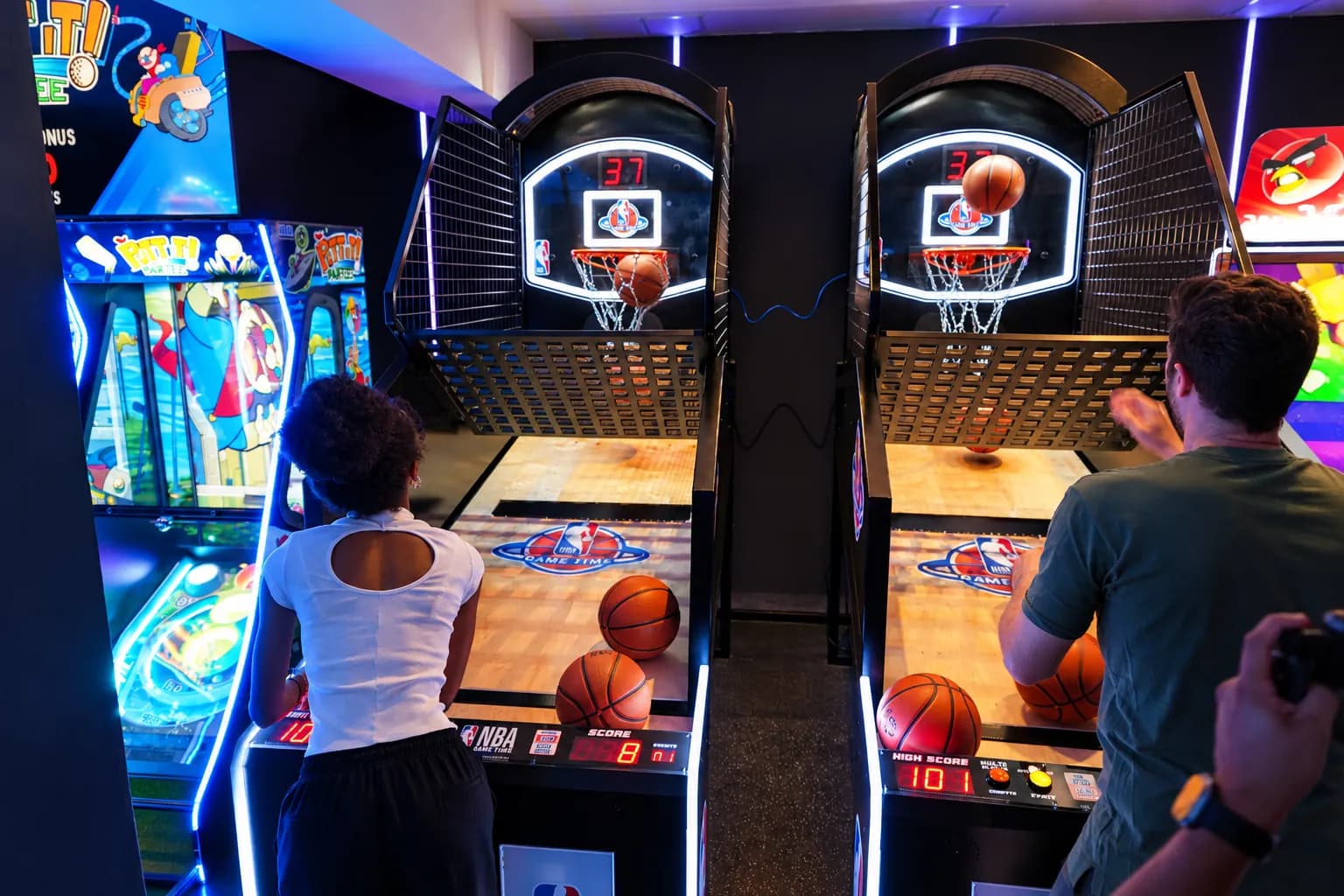 Teens enjoying games at Trobbu Secret Cave arcade